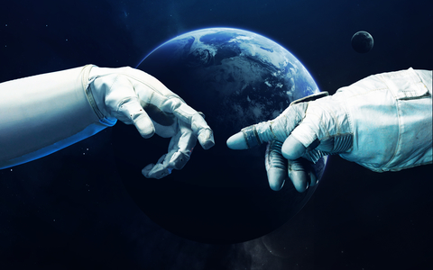 Two space-suited hands reach for one another in orbit around a planet