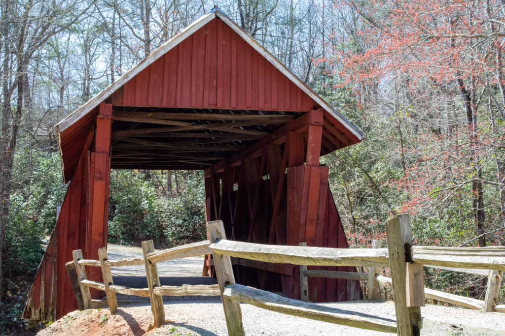 The road crossing an old red covered bridge