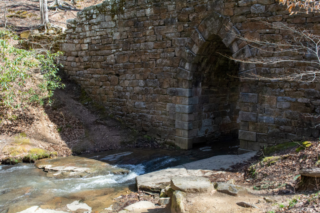 View of the base of an old stone bridge