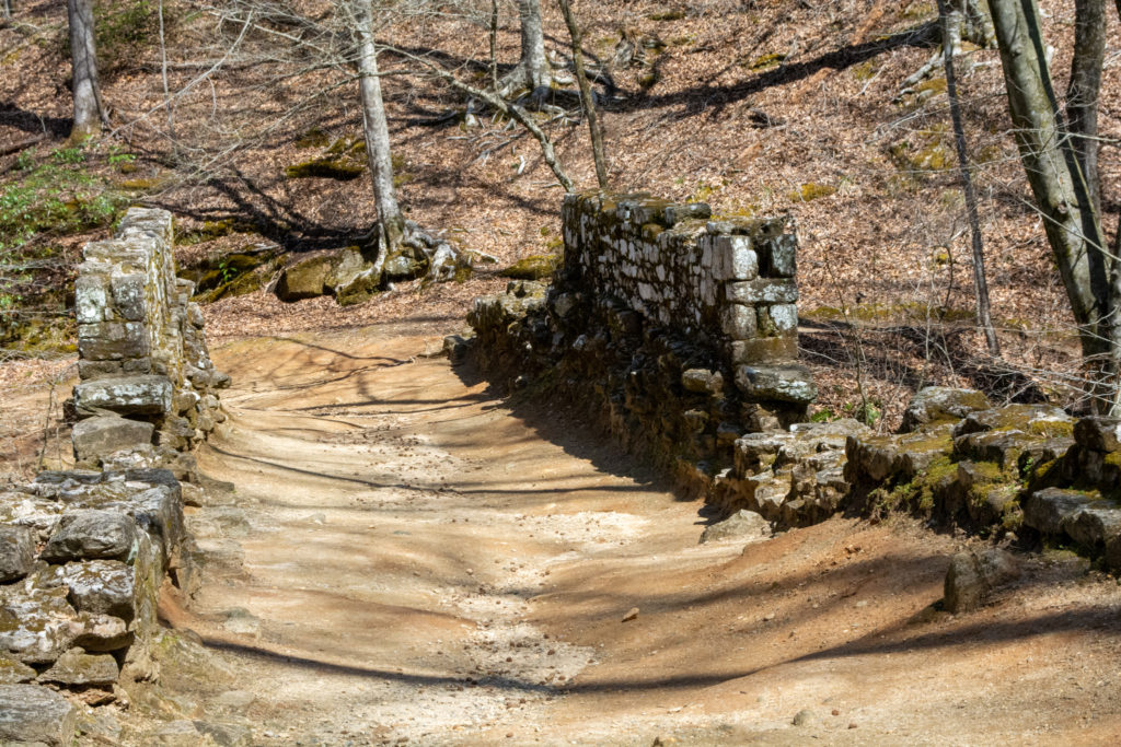 The road crossing an old stone bridge