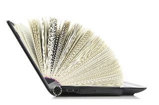 a laptop with book pages fanning out